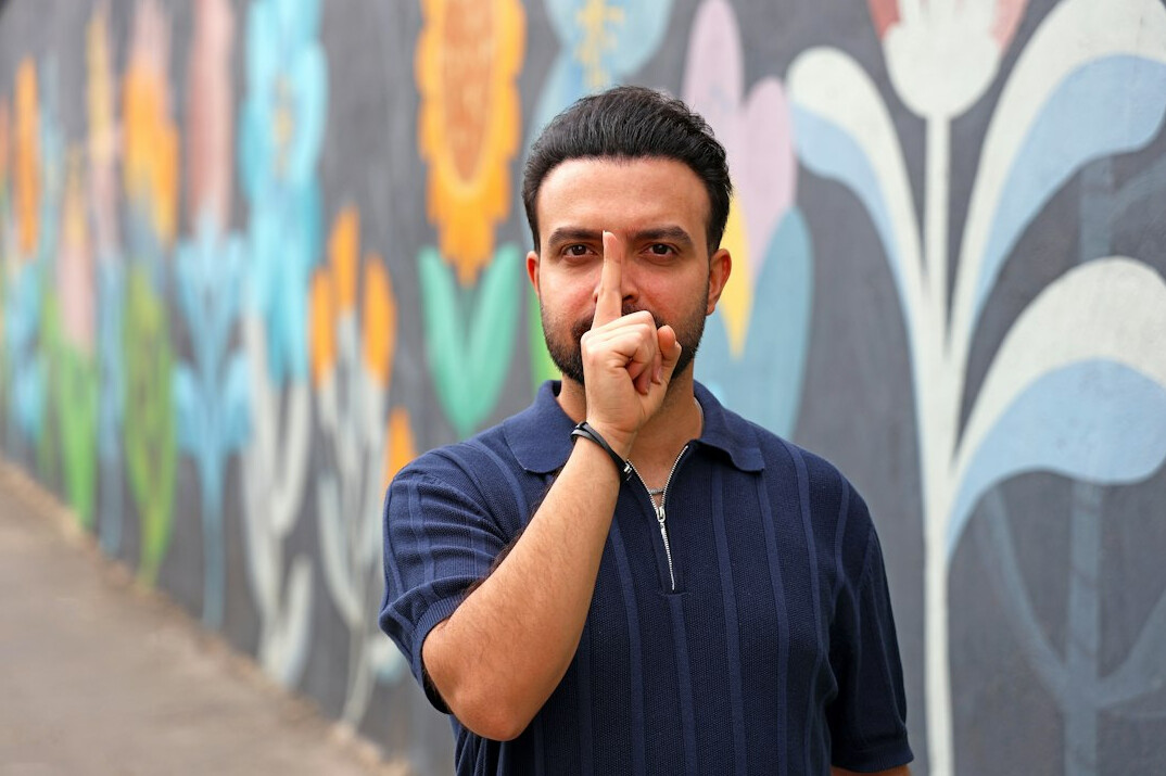 Portrait of a Welsh man with dark hair in a work shirt